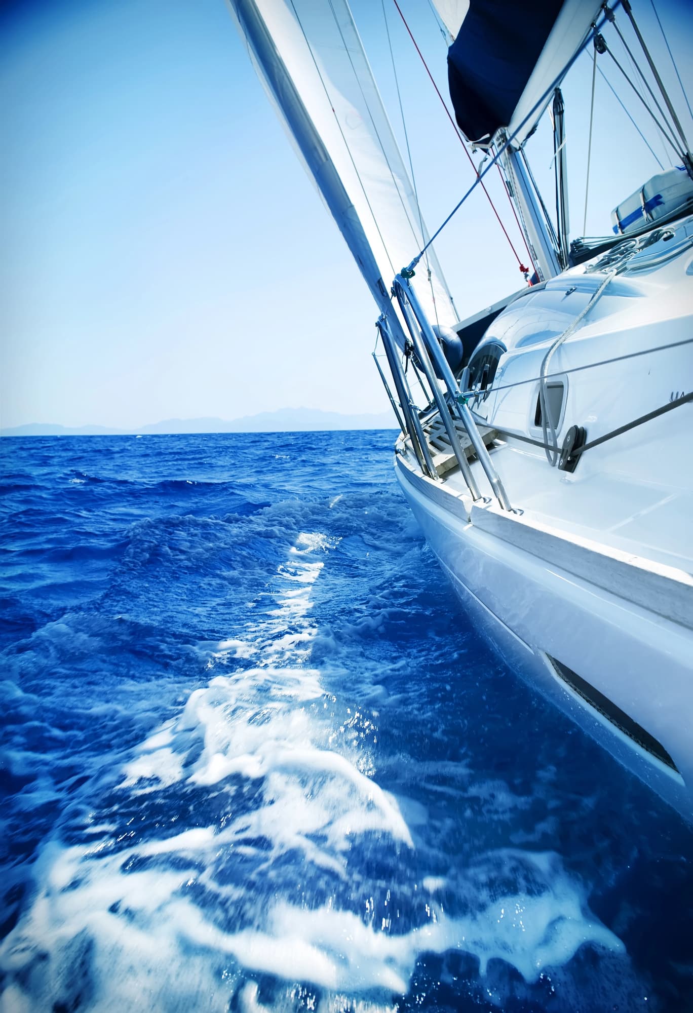 Sailboat cutting through open blue water near Florida, representing marine survey services
